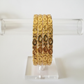 4 Gold Bangles on Acrylic Stand - White Background