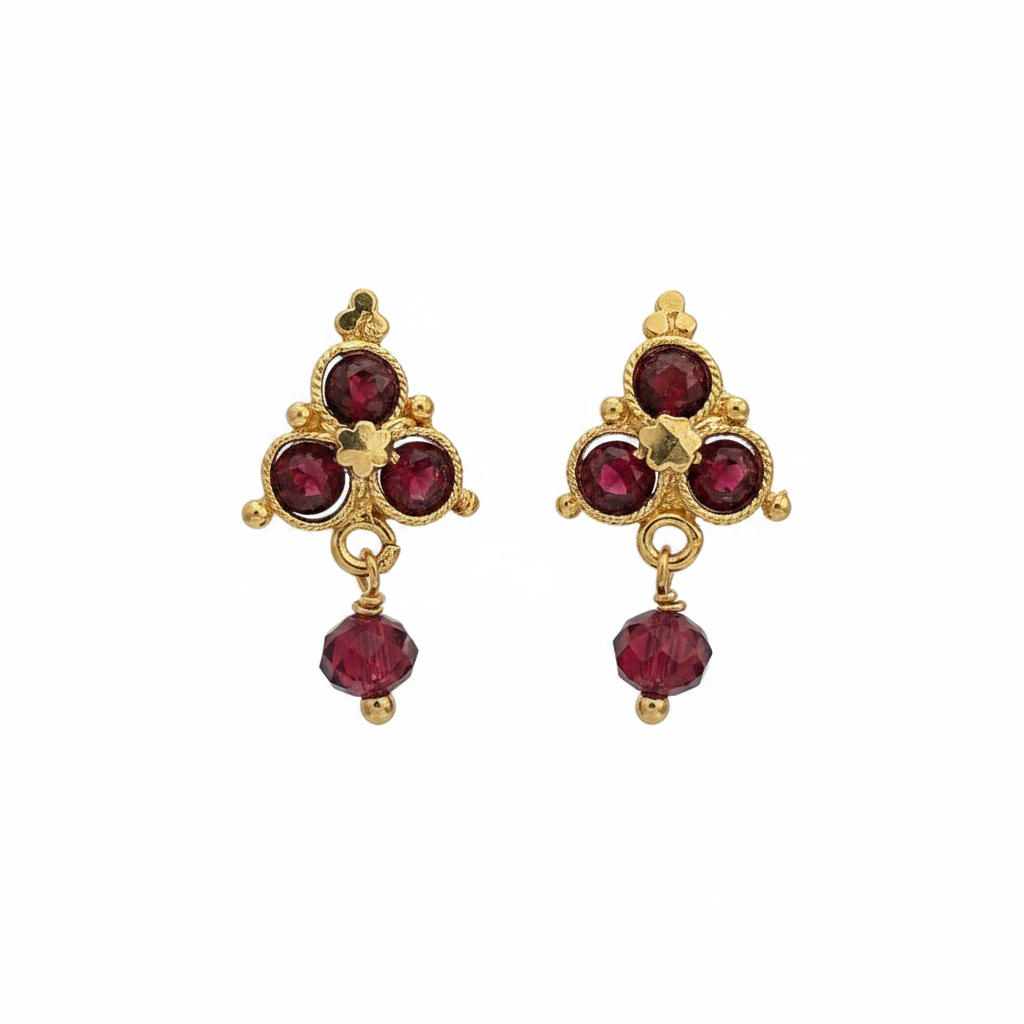 Gold and garnet cross cluster drop earrings on white background