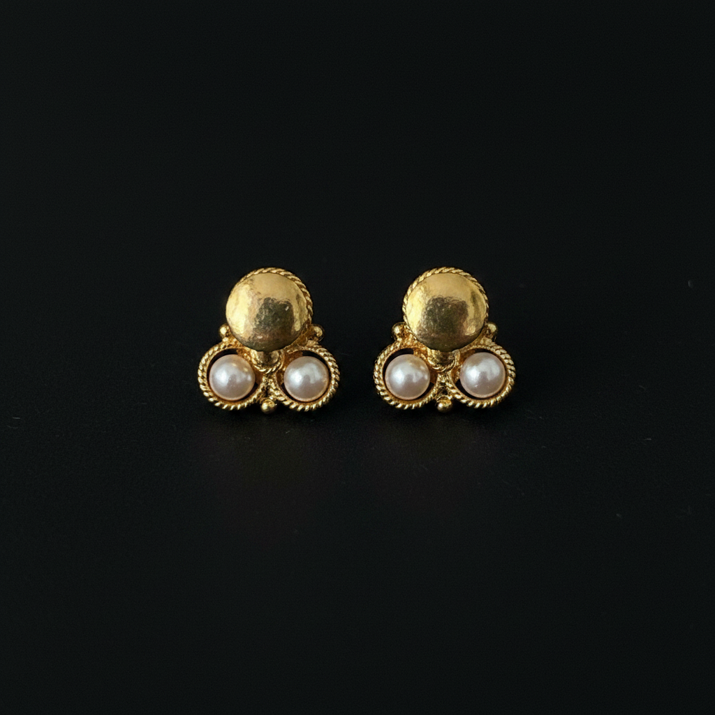 Triple pearl cluster gold stud earrings on black background